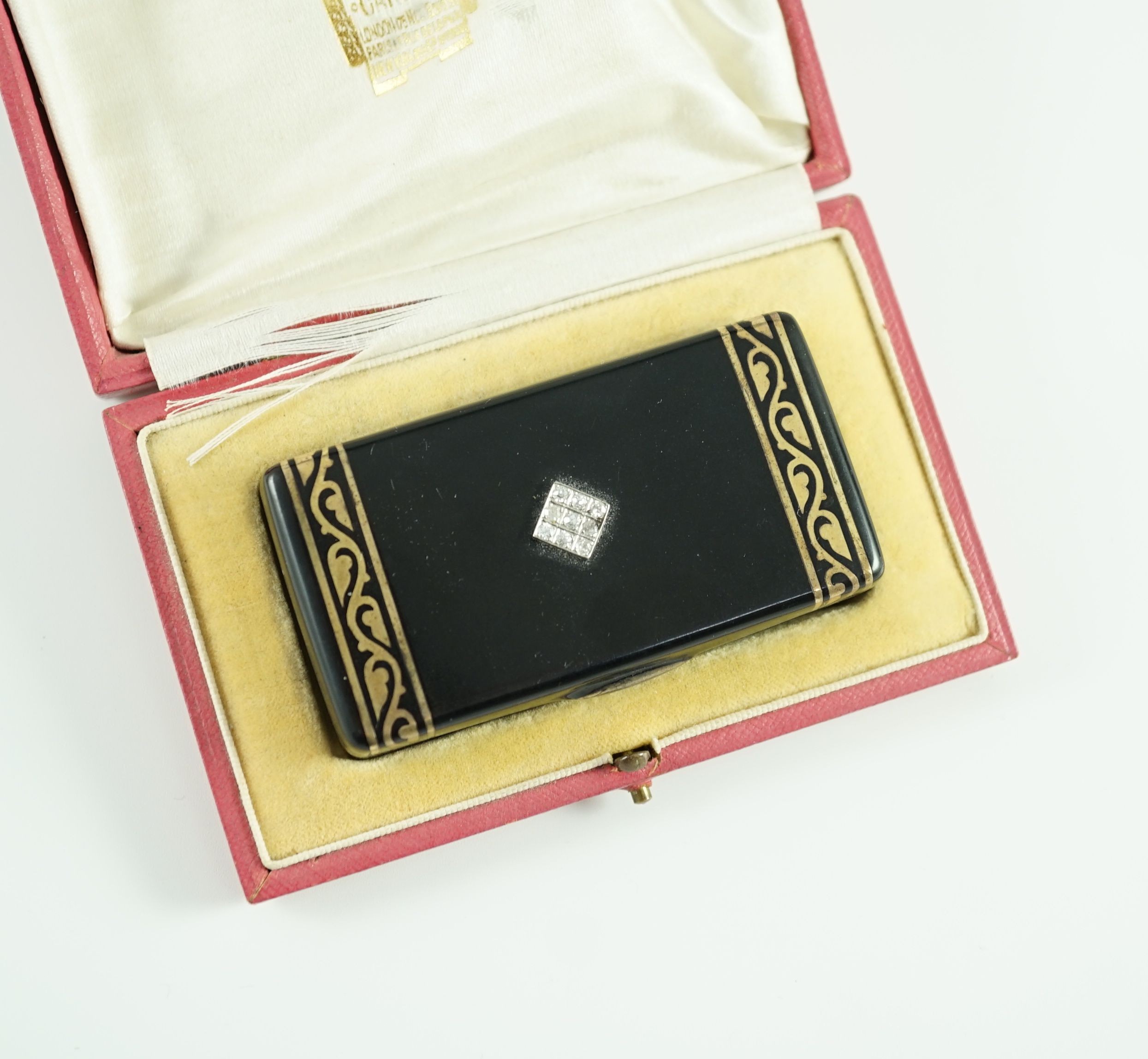 A late 1920's French Cartier silver gilt, black enamel and diamond set snuff box, in fitted gilt tooled leather Cartier box